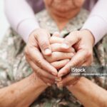 Caregiver holding hands Asian elderly woman patient, help and care in hospital.