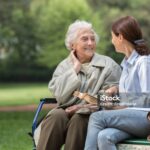 Senior woman with caregiver in the park
